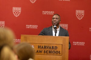 Man speaking at a podium at a Harvard Law School event
